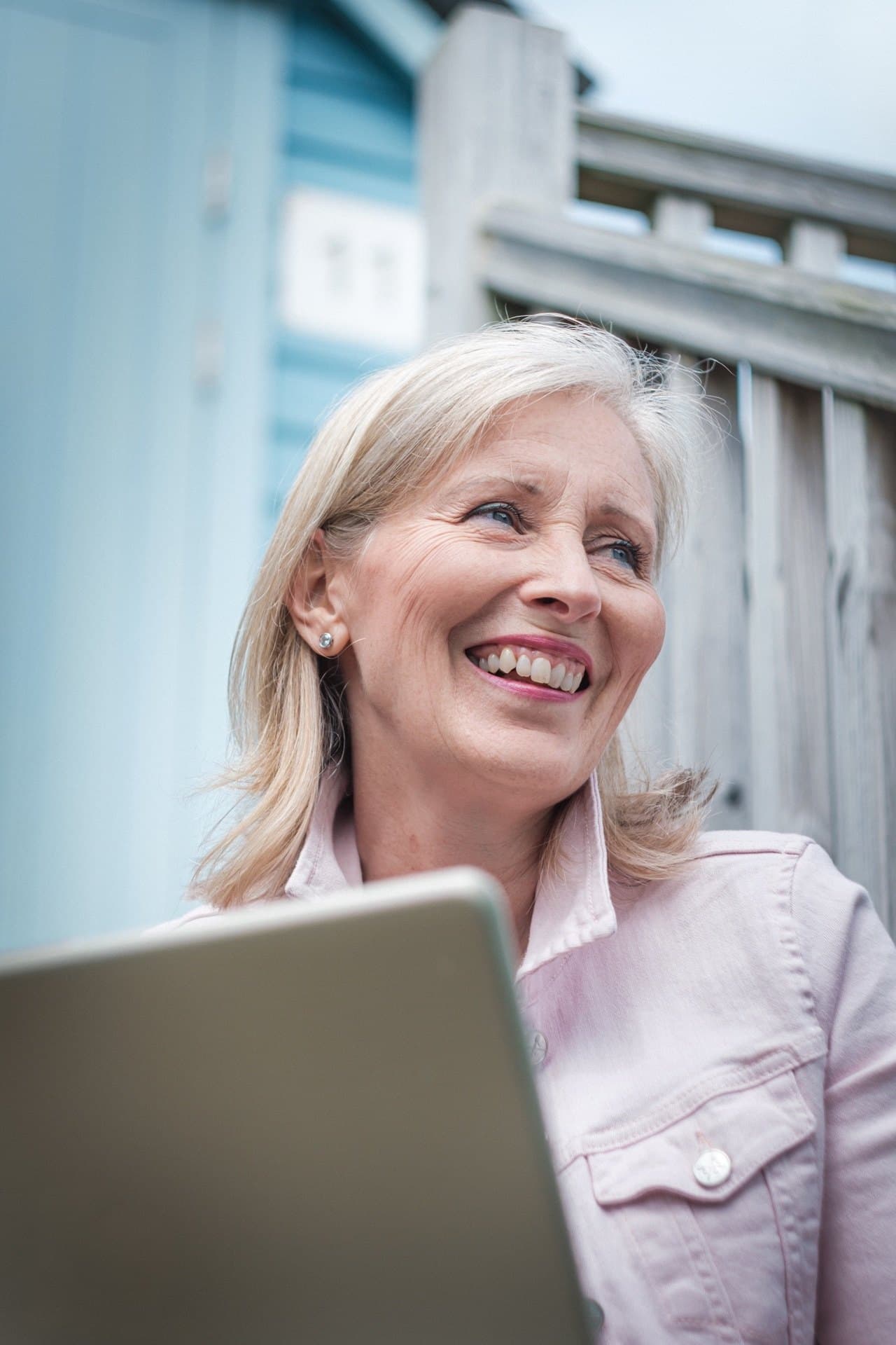 Gill Tiney working outdoors with laptop